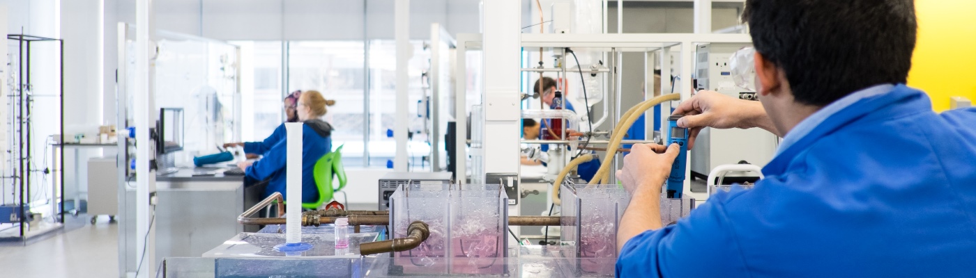 Students in a lab with chemical equipment
